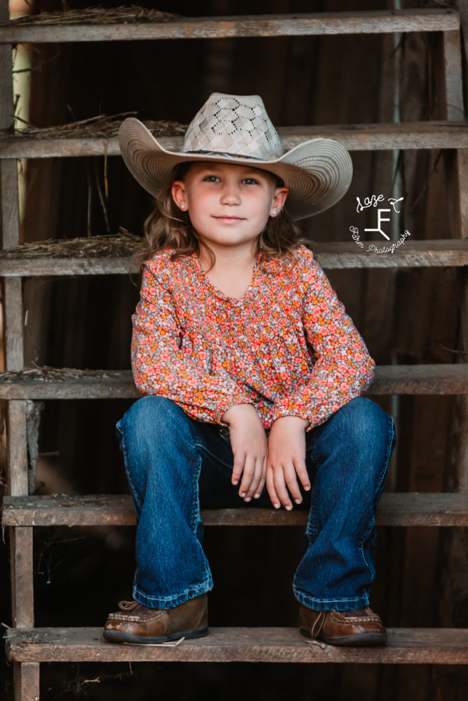 little cowgirl sitting on steps