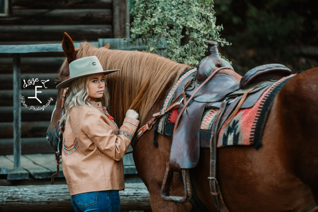 cowgirl in tan jacket with horse