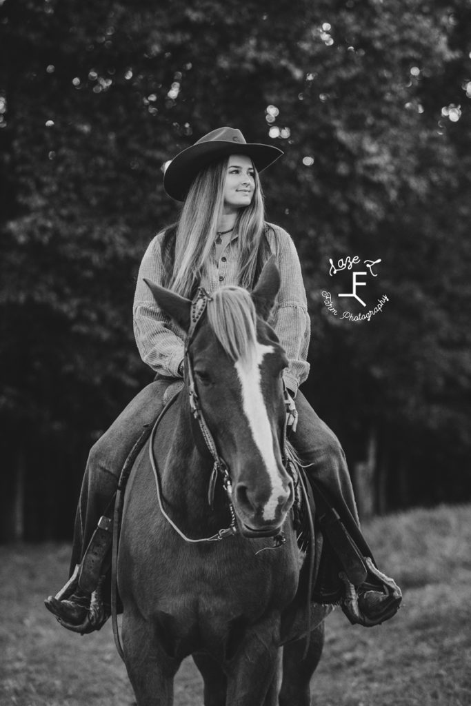 cowgirl on horseback in black and white