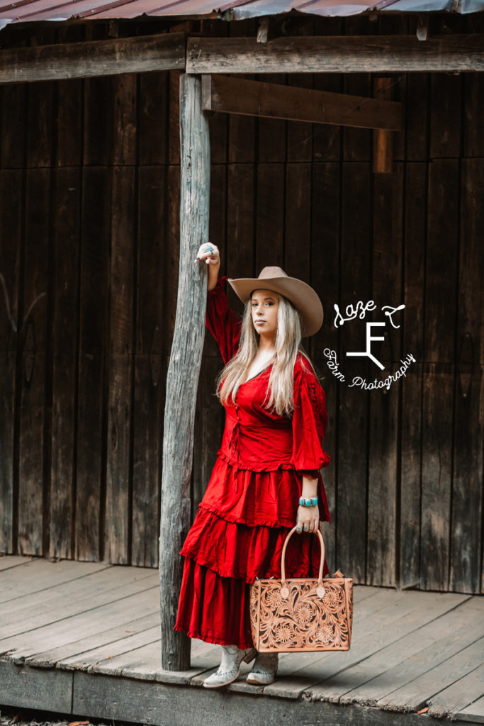 cowgirl in red dress with leather bag