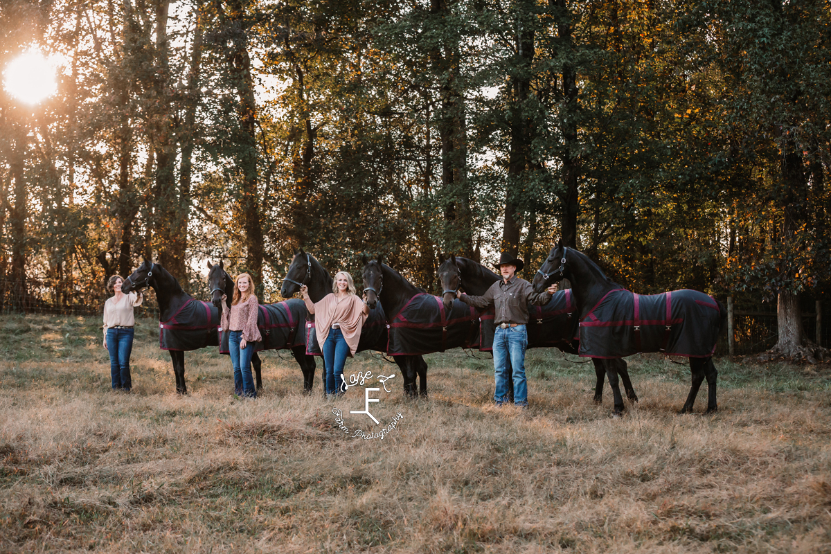 family of 4 with 6 black horses angled
