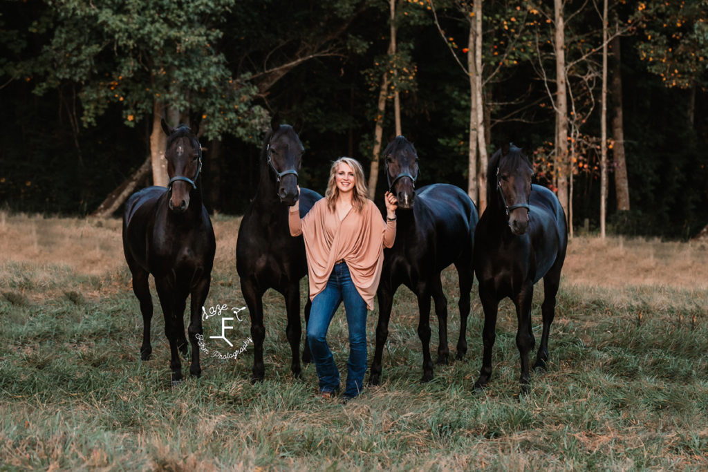 blonde with 4 black horses
