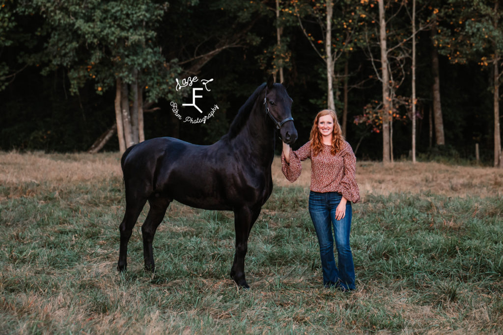 redhead lady with 1 black horse