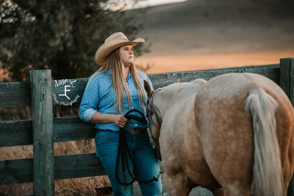 blonde cowgirl with palomino looking off to the right