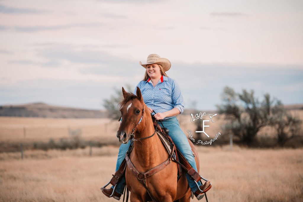 blonde cowgirl smiling while riding