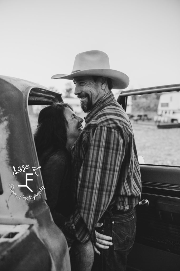 cowboy with wife in truck in black and white