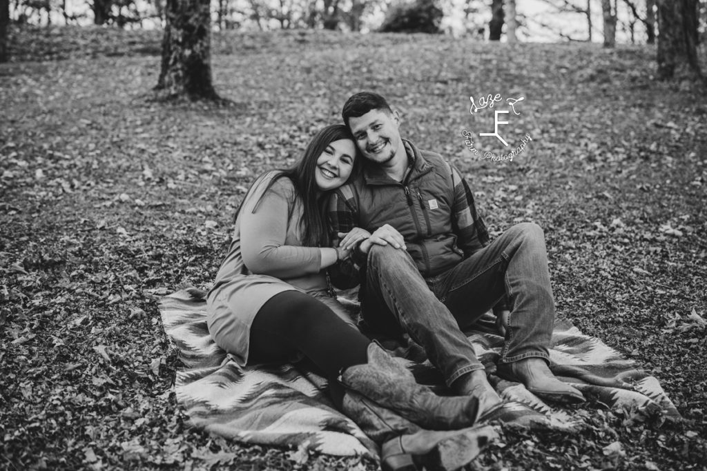 Couple sitting on blanket in black and white