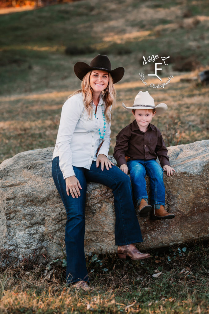 western mom and son sitting on rock