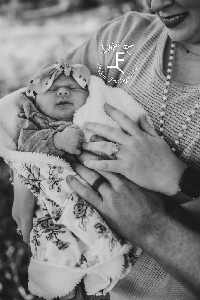 baby with wedding rings in black and white