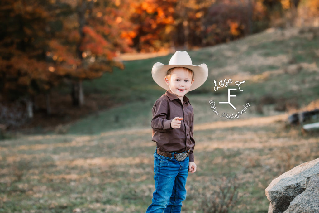 little cowboy pointing and smiling