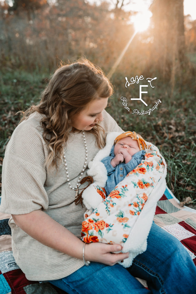 mom holding baby girl looking at her