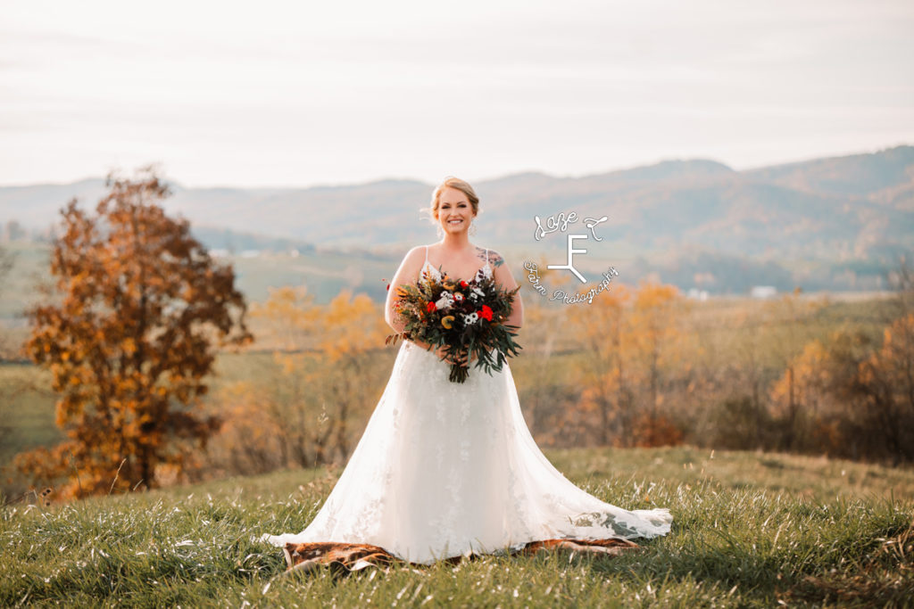 Bride with fall color bouquet on mountain top