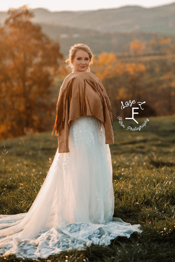 bride with fringe jacket looking over shoulder