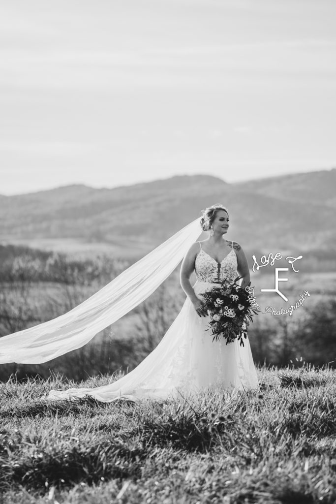 bride with veil blowing in wind in black and white