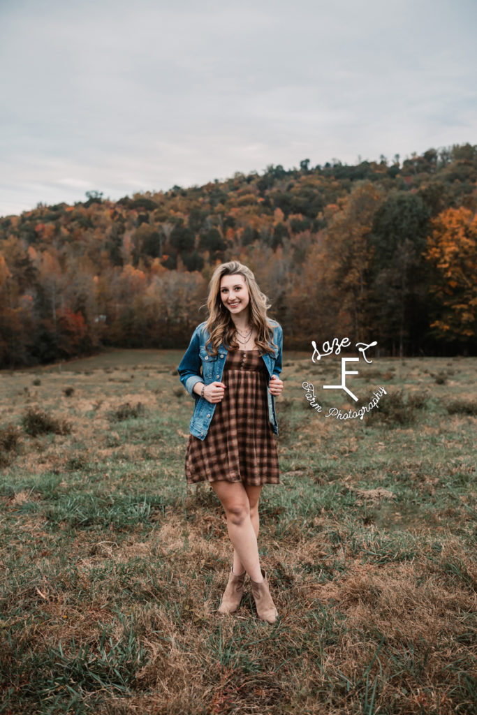 senior girl in plaid dress with blue jean jacket