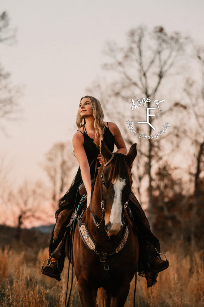 girl in black dress riding horse
