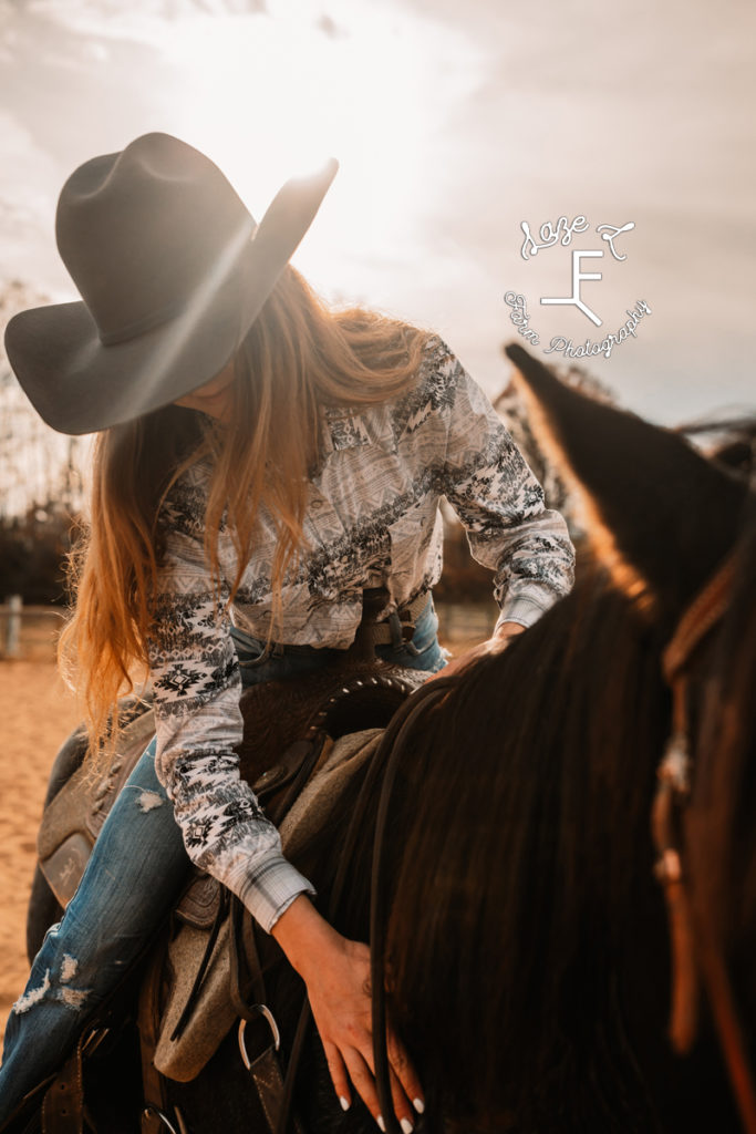 cowgirl riding and loving horse