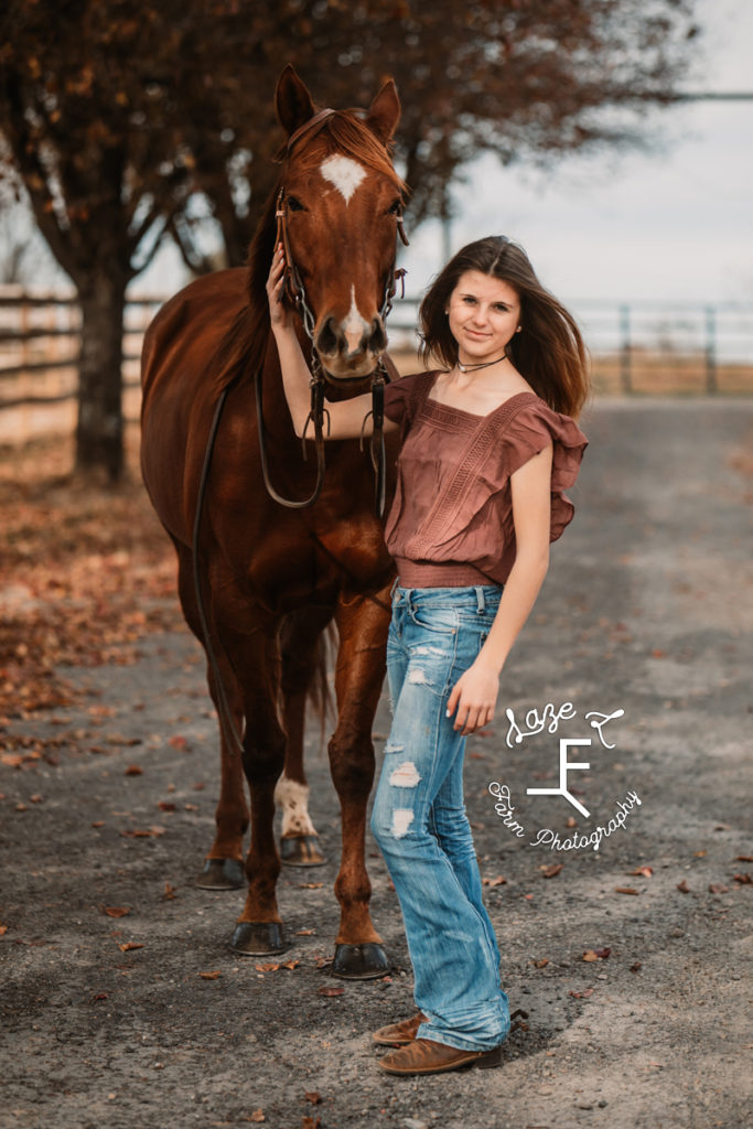 girl in jeans with red sorrel mare