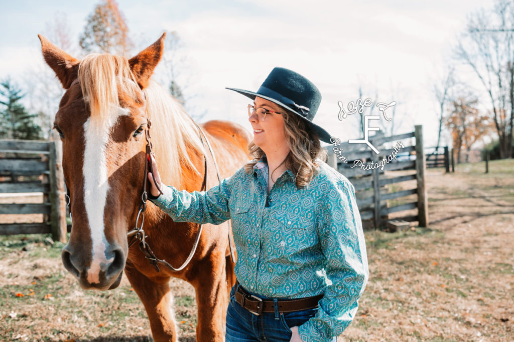 girl with horse in black felt hat