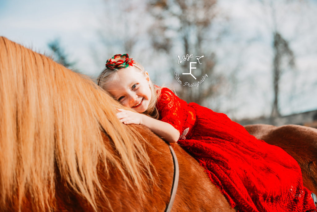 blond hair little girl on horse