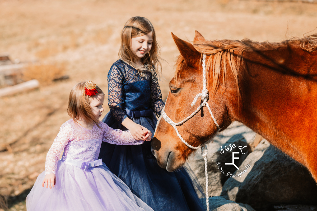 girls loving on horse