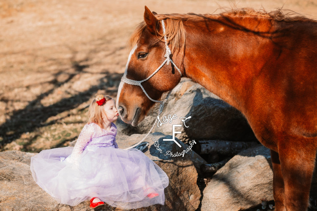little sister kissing horse