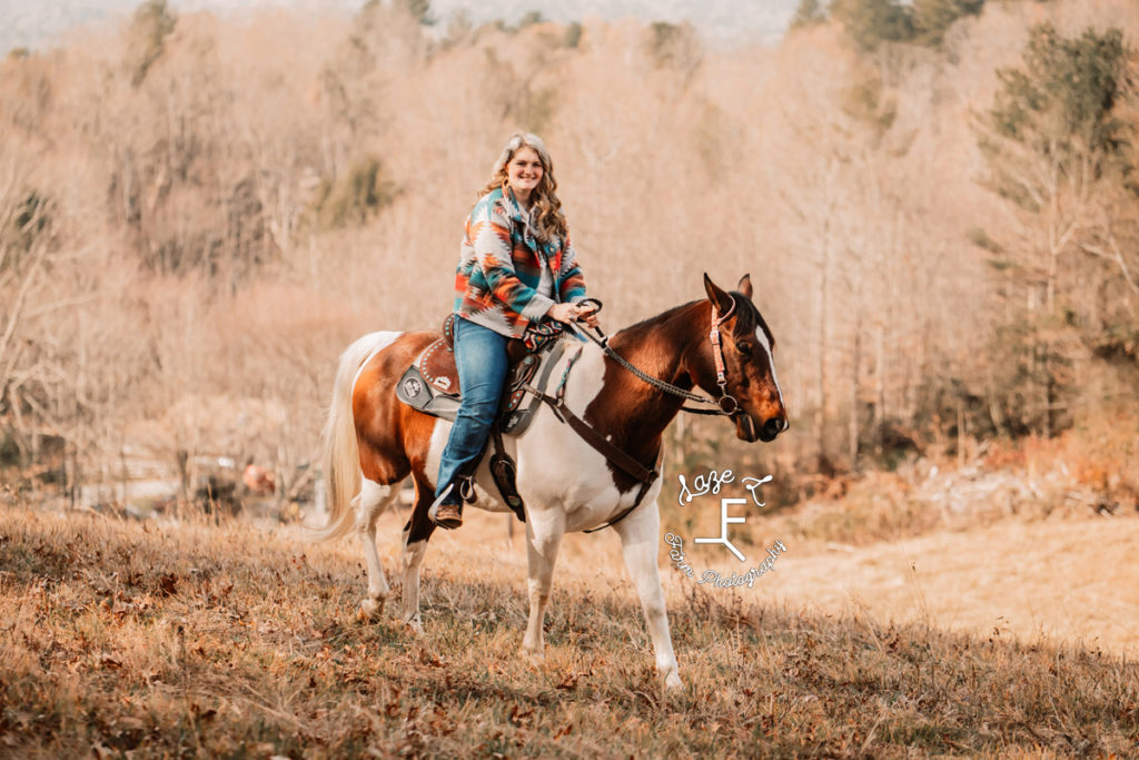 blond girl riding paint horse