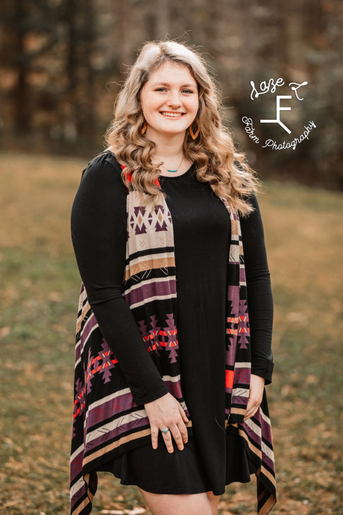 blond high school senior with Aztec print vest