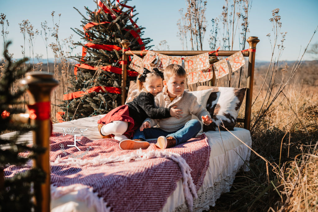 brother and sister on Christmas bed