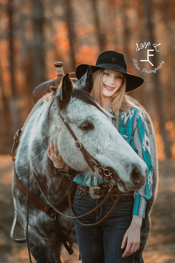 redhead cowgirl with gray horse