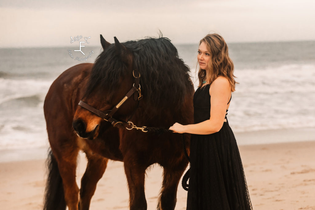 girl in black dress with shire horse