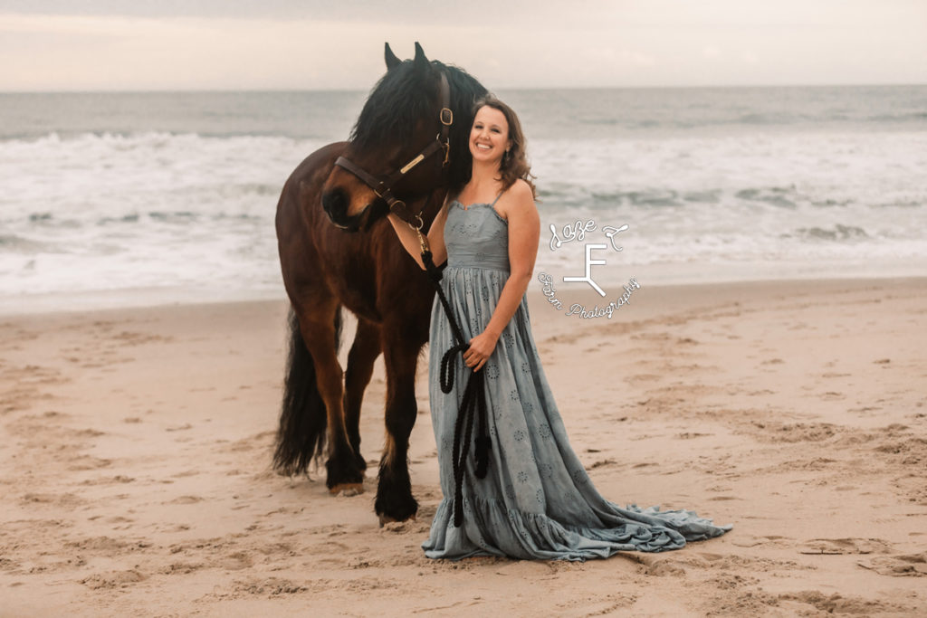 girl in blue dress with shire horse