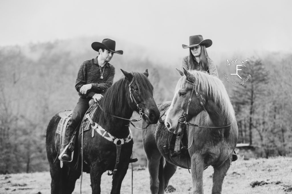 cowboy couple with horses in black and white