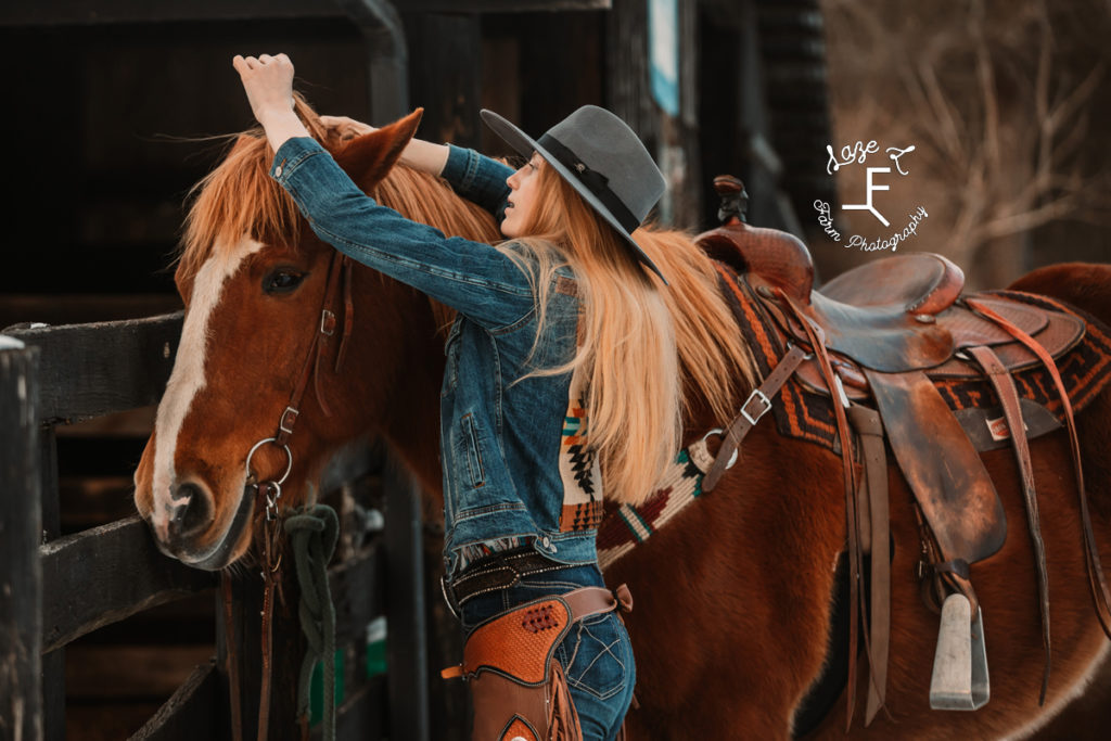 redhead cowgirl getting horse ready