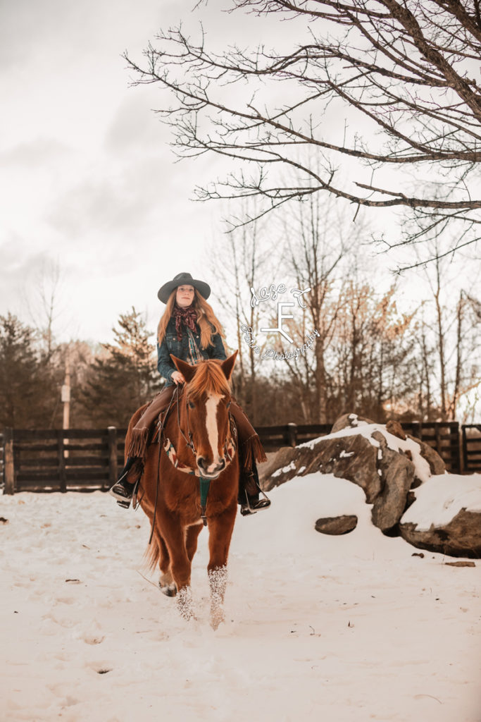 cowgirl riding in the snow