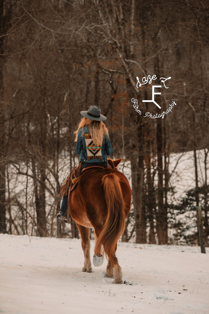 red head cowgirl riding away