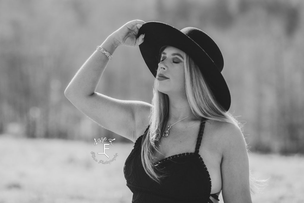 cowgirl in black hat in black and white