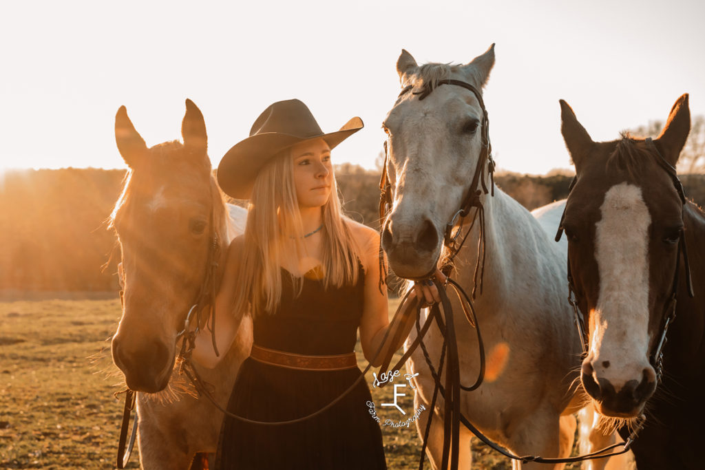 closeup cowgirl with 3 horses