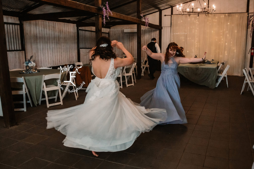 bride with bridesmaid on dance floor