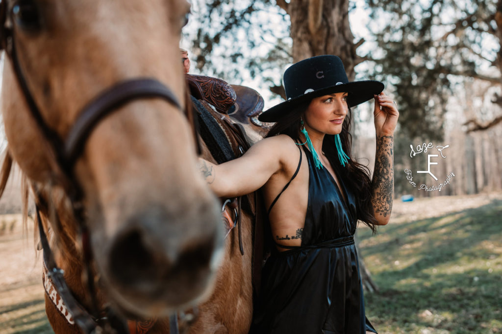 cowgirl with horse in black hat