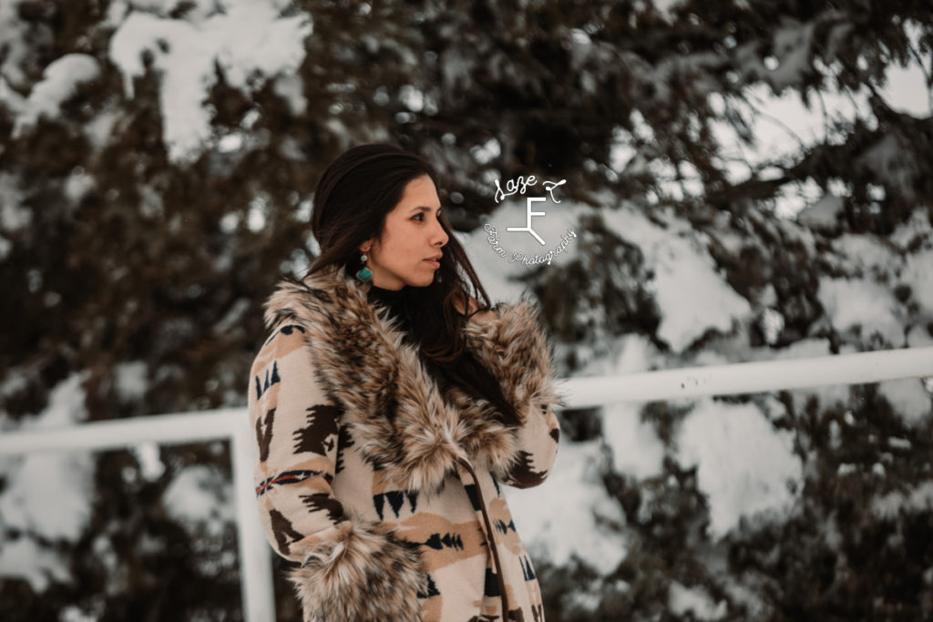 girl in Aztec print fur trimmed coat looking away