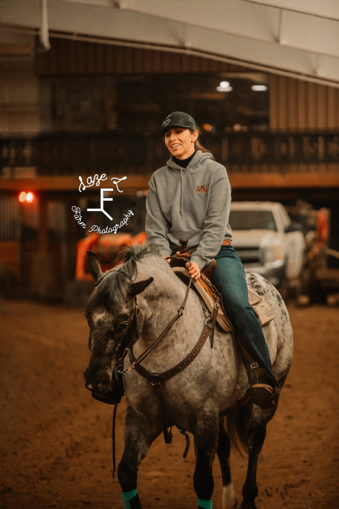 girl riding appaloosa in indoor arena