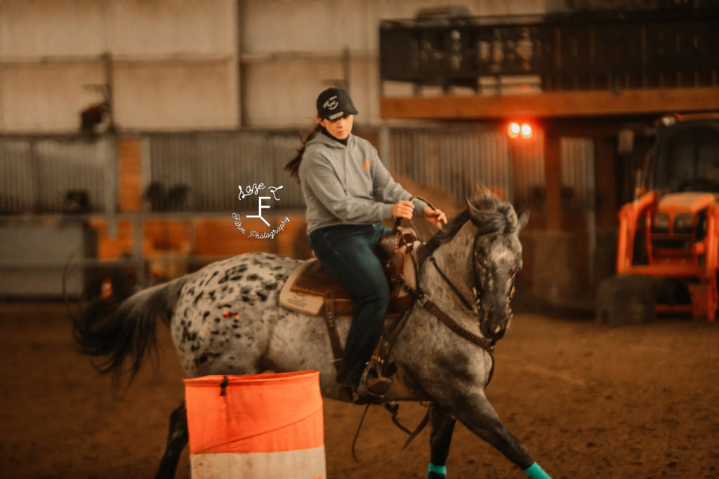 barrel horse and rider turning around barrel