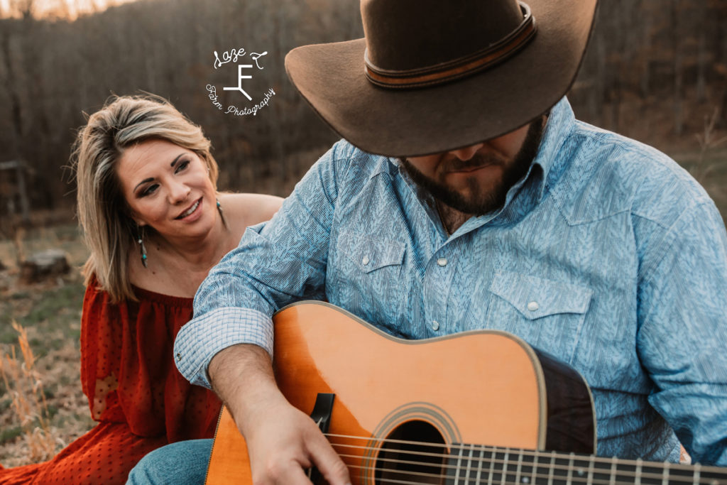 cowboy playing guitar with fiancé