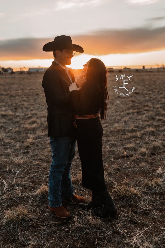 western couple embracing at sunset