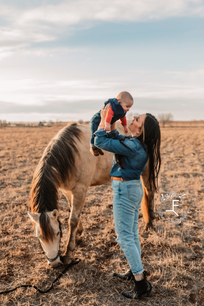 western mama with baby boy and horse