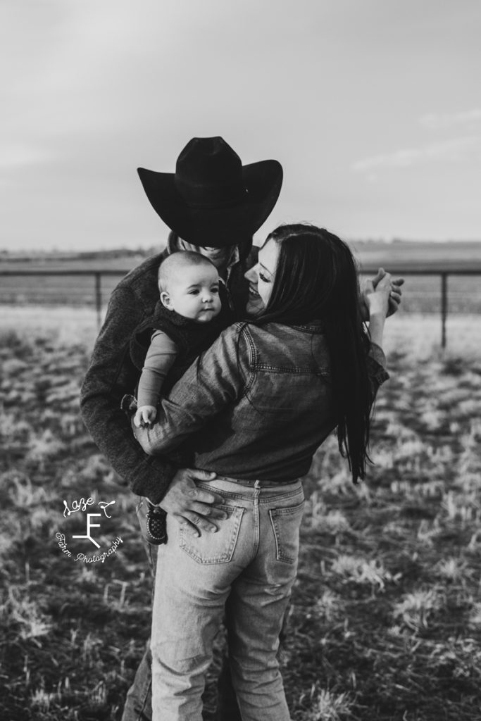 western couple 2 stepping holding baby