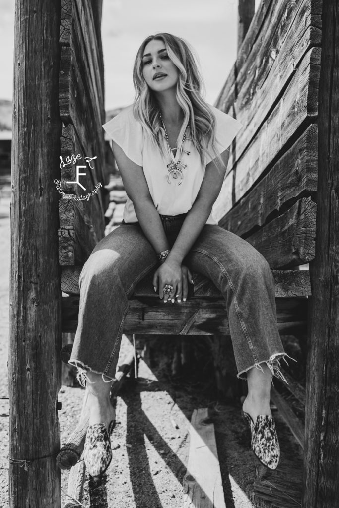 blonde model sitting on wood slats in black and white