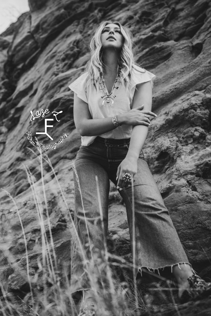 blonde model in front of rocks in black and white