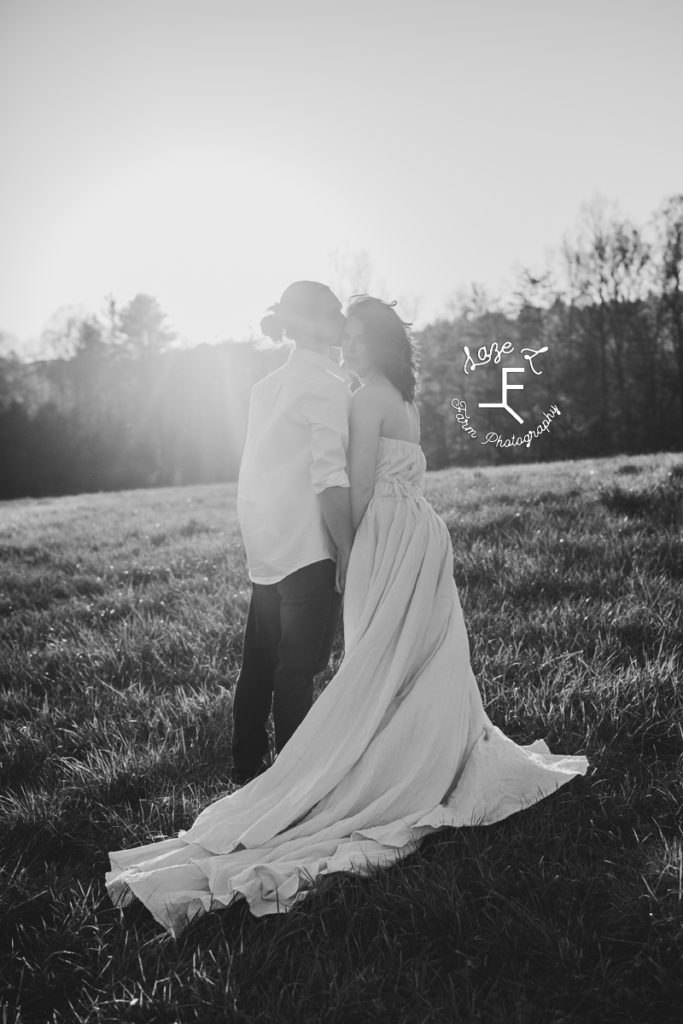 couple standing on a hill in black and white